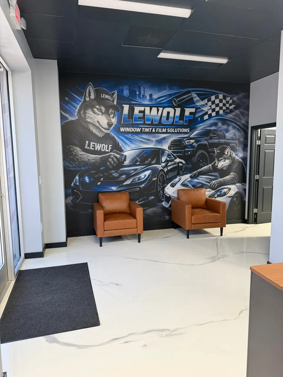 LeWolf Window Tint and Film Solutions customer lounge with wolf mural in Magnolia, Texas