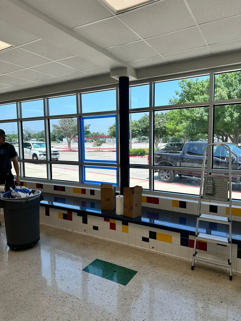 LeWolf technician installing safety and security film on a Texas school classroom window wall